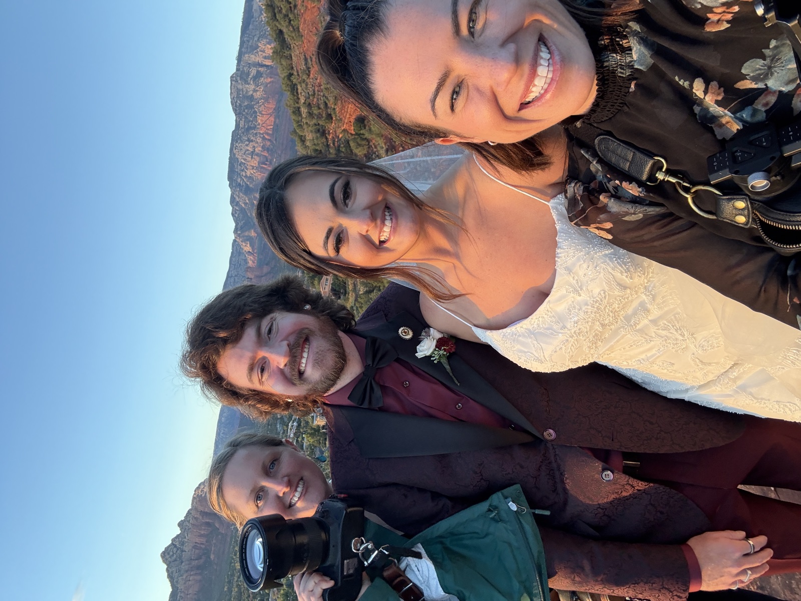 Wedding filmmakers with a newlywed couple in Sedona at sunset