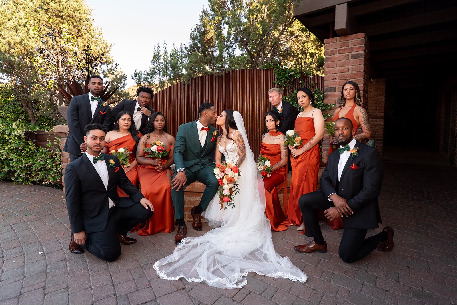 Sedona newlyweds surrounded by their wedding party at an outdoor venue